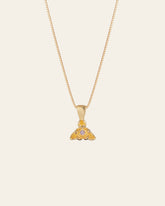 The Elsa Violet Amethyst Necklace by CAMELLIA is a handcrafted gold pendant necklace with intricate designs and small gemstones, elegantly suspended on a fine chain, set against a plain background.